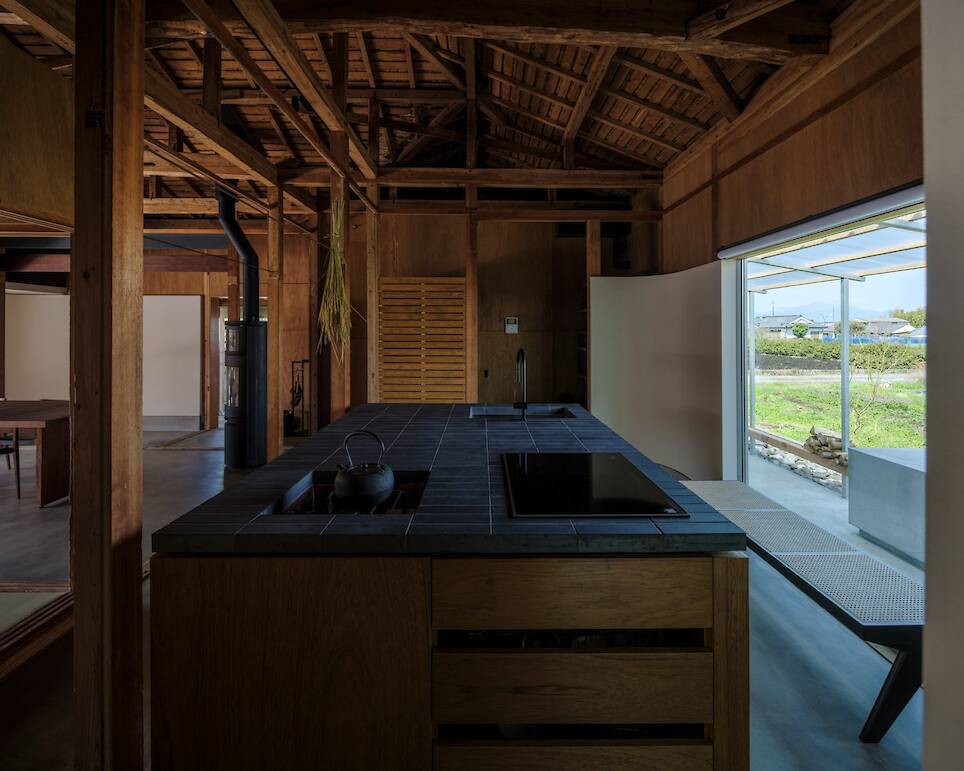 A sunken hearth features in the indoor kitchen
