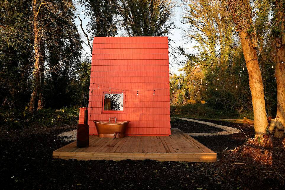 This Tiny Red Cabin Has a Lockbox for Your Phone