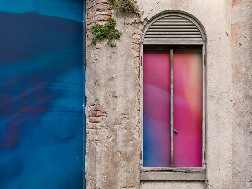 Colorful printed textile installation reimagines historic laundry building facade in switzerland