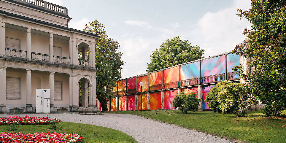 Colorful printed textile installation reimagines historic laundry building facade in switzerland