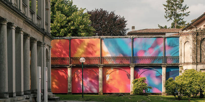 Colorful printed textile installation reimagines historic laundry building facade in switzerland