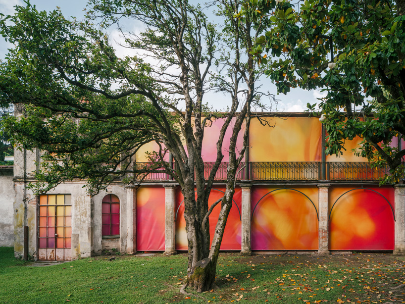 Colorful printed textile installation reimagines historic laundry building facade in switzerland