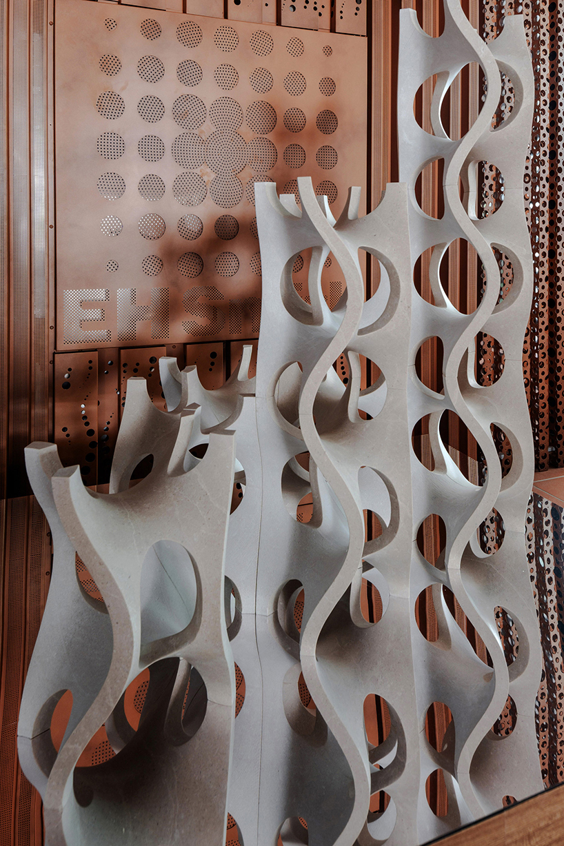 Robotic carving transforms reclaimed stone waste into porous modular system