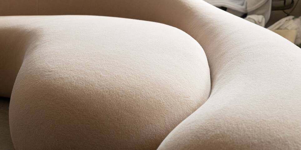 Soft monolithic forms shape a modular furniture collection in nubuck, alpaca, and oak