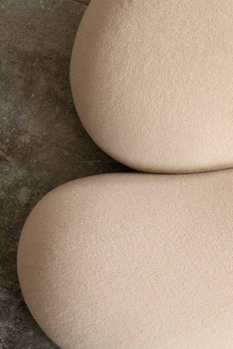 Soft monolithic forms shape a modular furniture collection in nubuck, alpaca, and oak