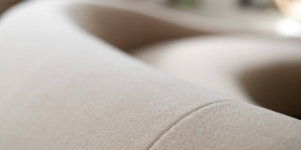 Soft monolithic forms shape a modular furniture collection in nubuck, alpaca, and oak