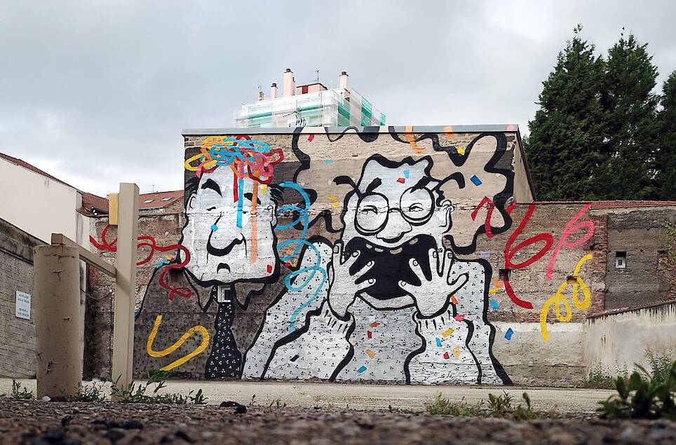 a mural by Ella & Pitr on a wall featuring two cartoonish figures, one laughing
