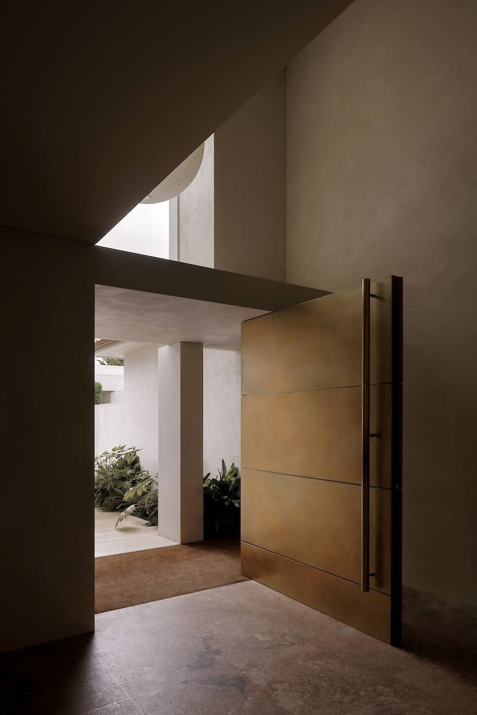 view from hallway through open large wooden door of home