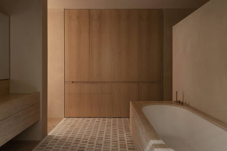 Minimalist neutral bathroom with wooden storage doors