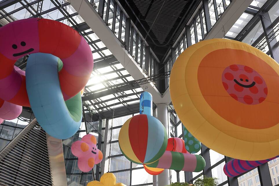 an inflatable installation of colorful shapes with smiley faces by craig and karl