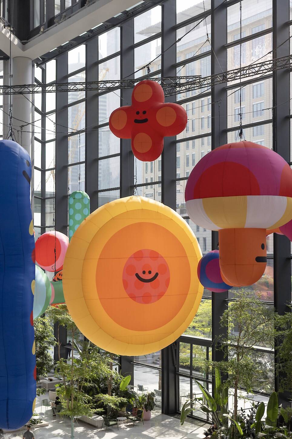 an inflatable installation of colorful shapes with smiley faces by craig and karl