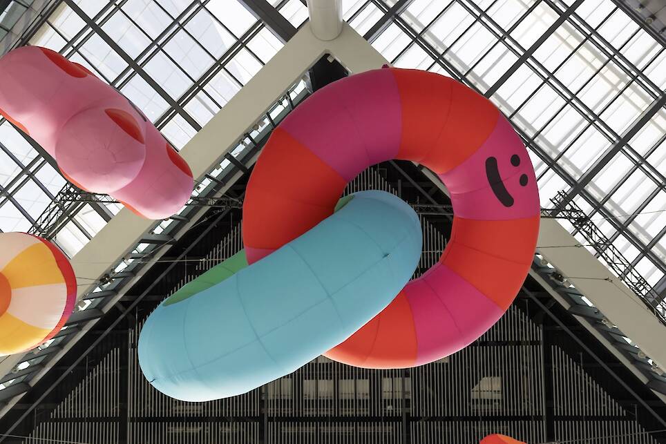 an inflatable installation of colorful shapes with smiley faces by craig and karl
