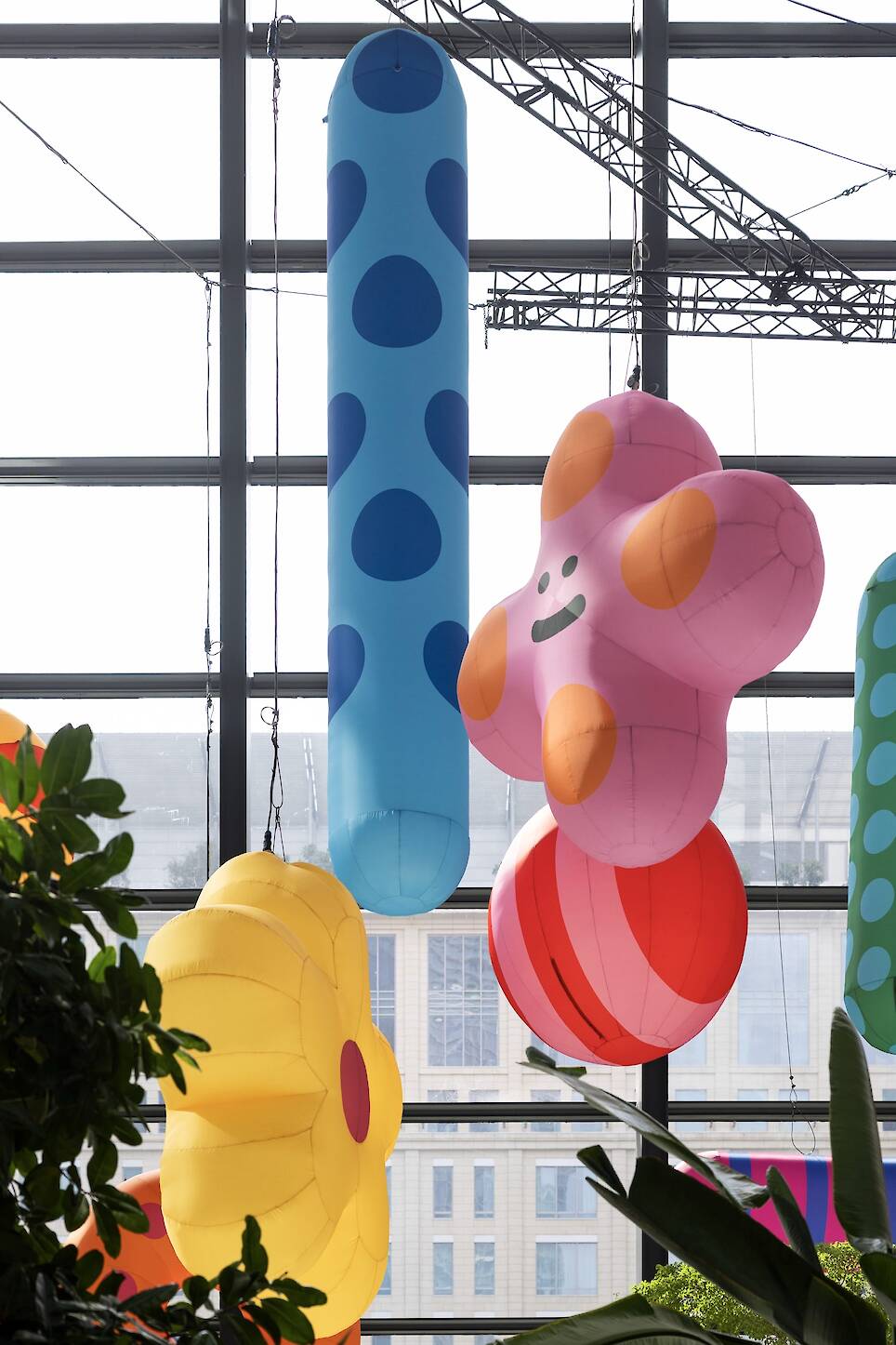 an inflatable installation of colorful shapes with smiley faces by craig and karl