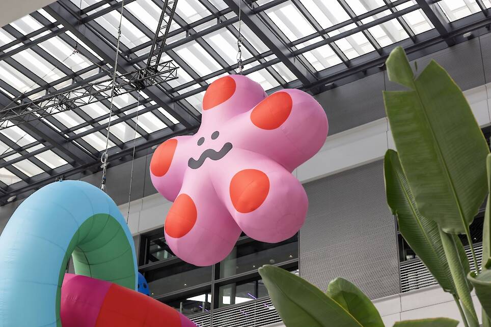 an inflatable installation of colorful shapes with smiley faces by craig and karl
