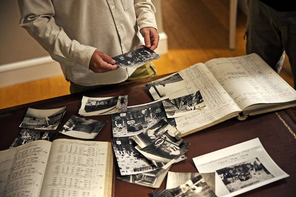 <p>Daniel Arsham looks through archival imagery of The Balvenie distillery</p>