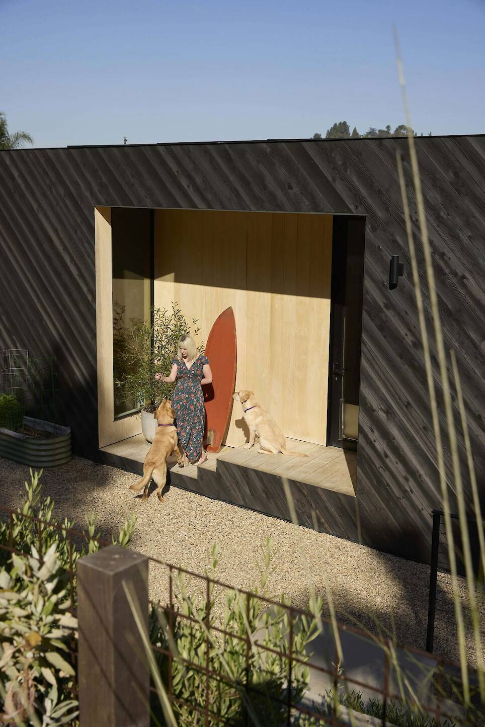 Ruth stands near the rear entrance of the second floor with the couple’s English Labs, Rolo and Toffee. "This house is a giant dog run," Scott says with a laugh