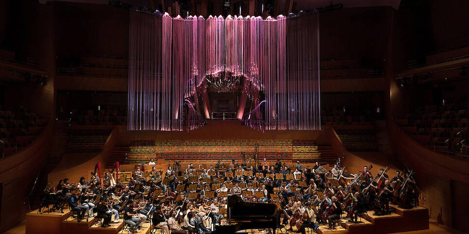 the full span of the work centered above the stage