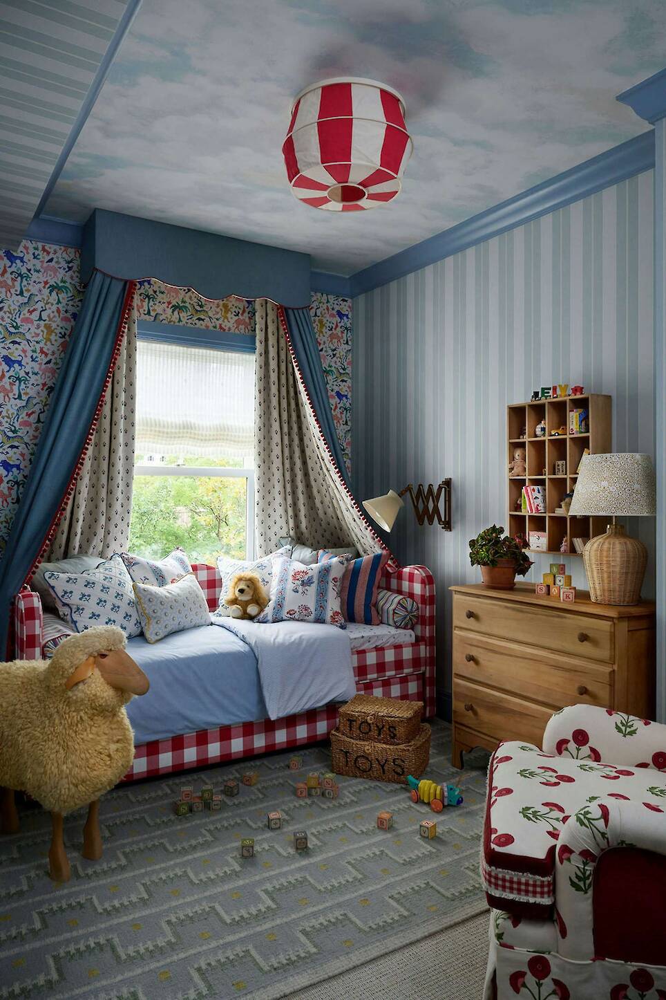 The wallpaper in this children’s bedroom is Schumacher’s Beasts; the designers said they hoped the clouds on the ceiling inspired an adult to use the paper in their own room
