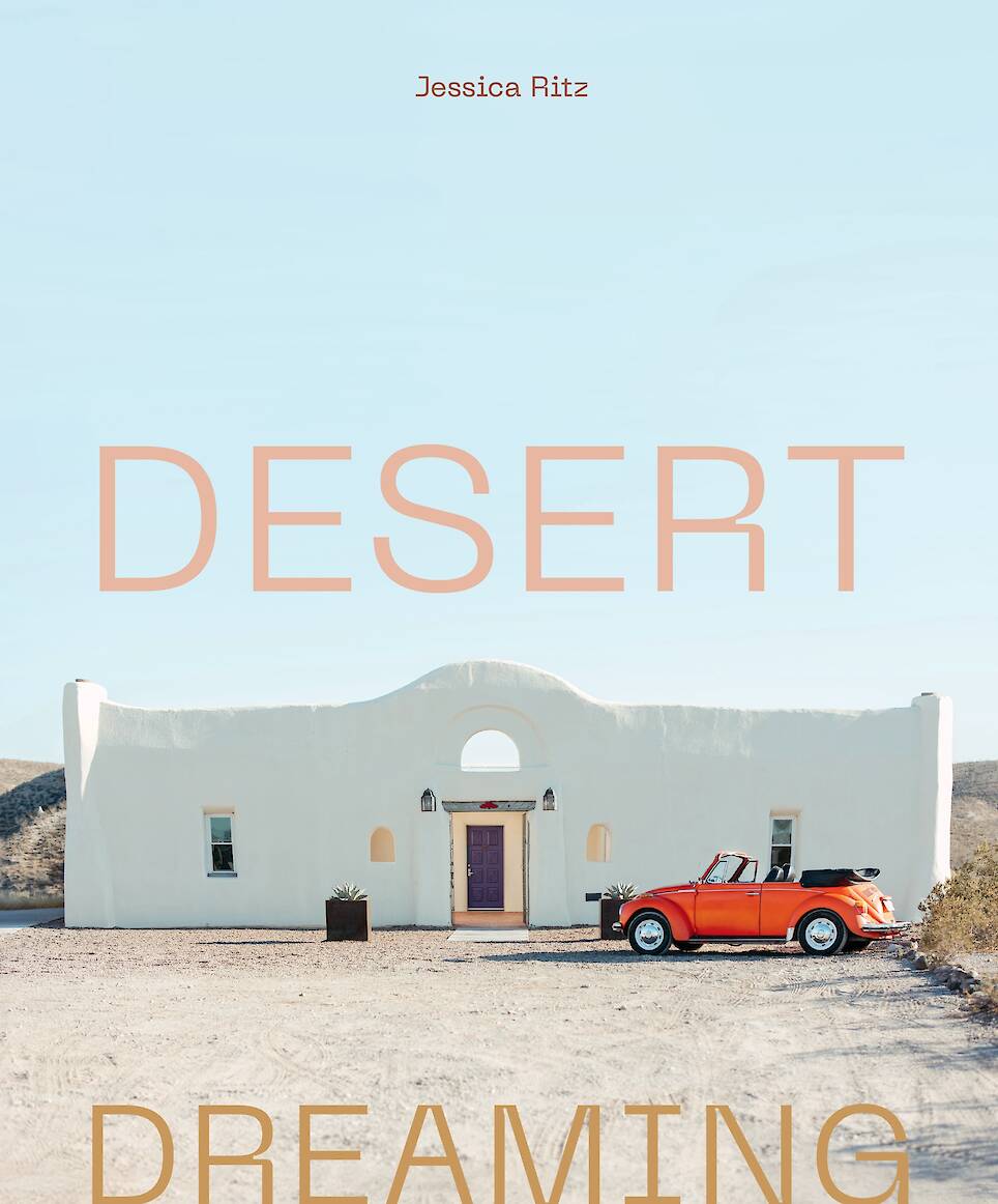 Desert Dreaming book cover showing white building against desert soil and clear blue skies
