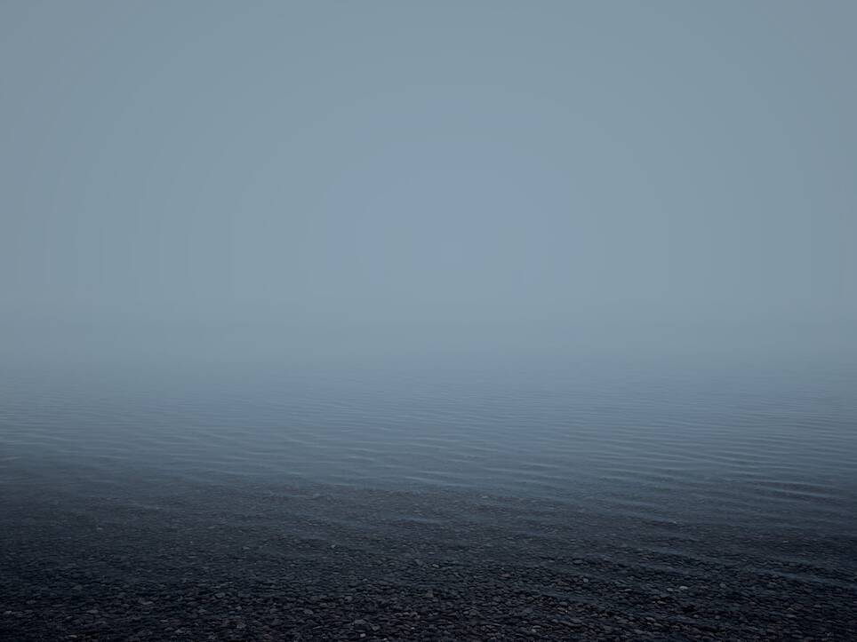an open body of water on a foggy day