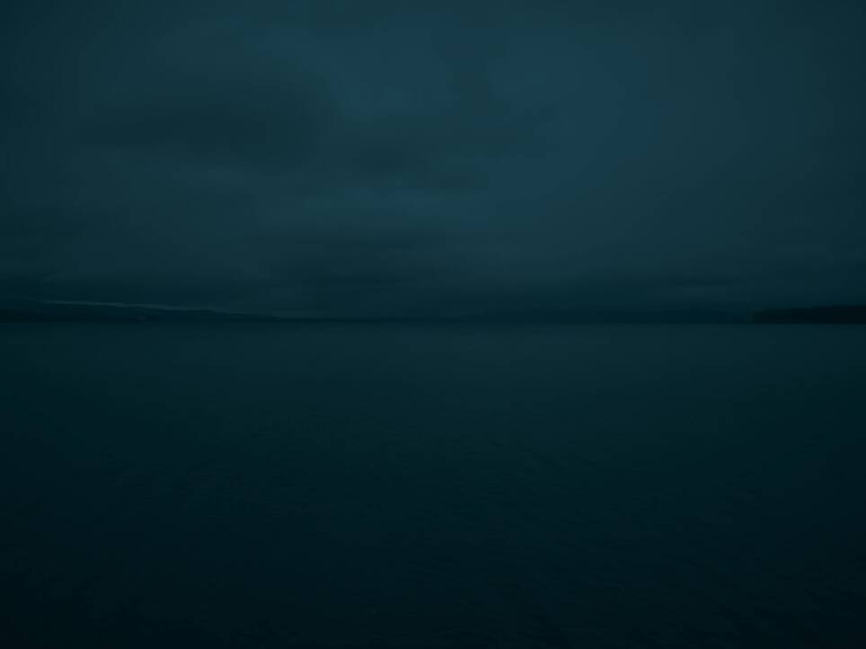 a dark, moody image of an open body of water